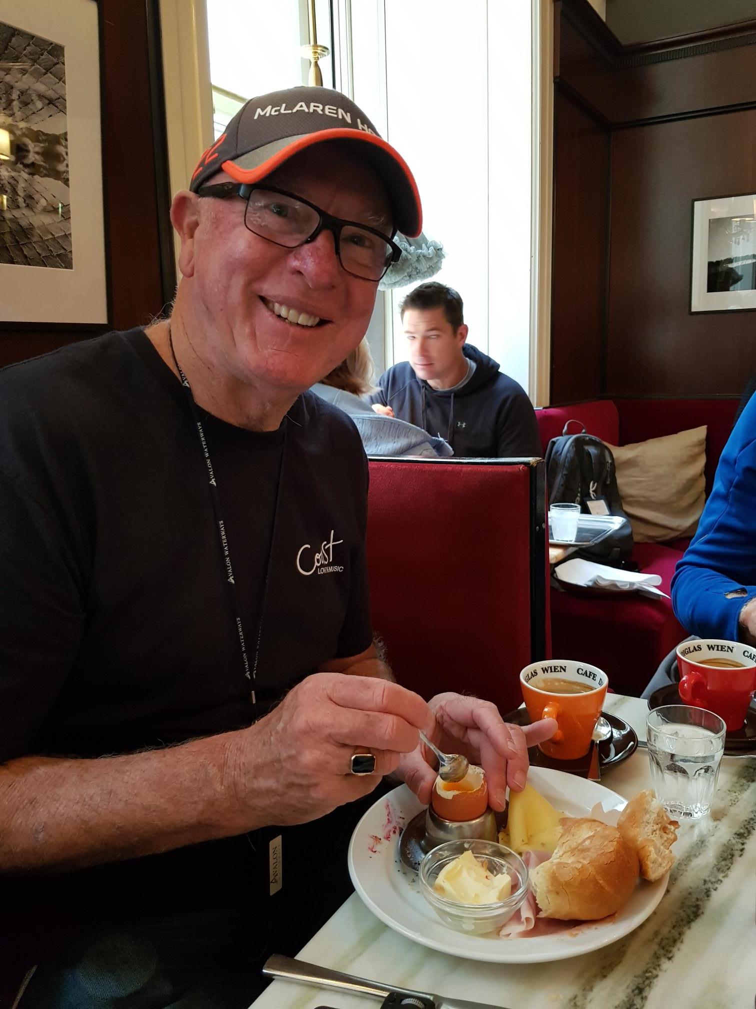 Experiencing a traditional breakfast in Vienna; boiled egg, bread and ham with coffee.