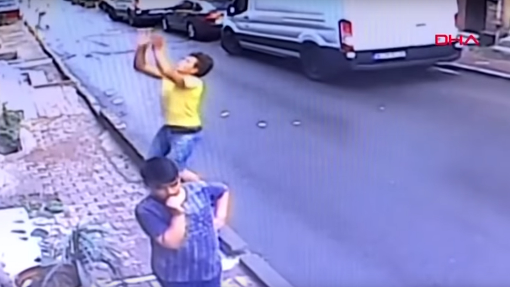 Watch the terrifying moment a baby falling from window is caught by boy walking by
