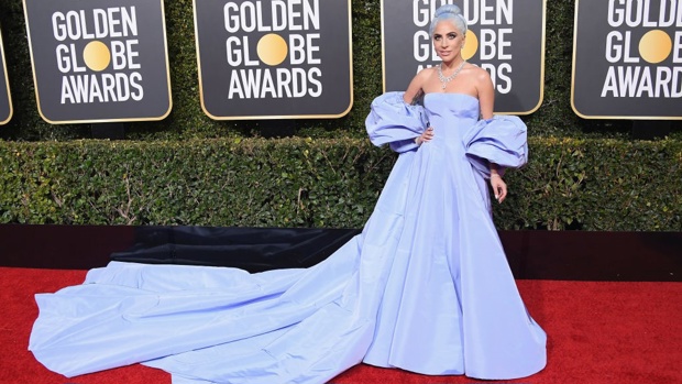 Gaga in the blue Valentino dress, believed to be in homage to Judy Garland from the original 'A Star is Born' film from 1954. Image / Getty