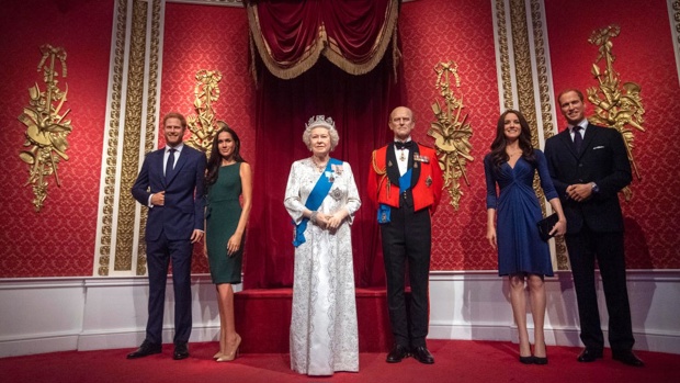 The figures of the Duke and Duchess of Sussex in their original positions next to Queen Elizabeth II, the Duke of Edinburgh, and the Duke and Duchess of Cambridge, as Madame Tussauds London moved its figures of the couple from its Royal Family set / Getty Images