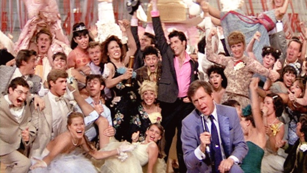In foreground with microphone, Edd Byrnes as Vince Fontaine in the 1978 film 'Grease'