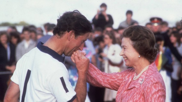 Charles kisses the hand of his mother, Queen Elizabeth II, at a polo match in 1985. Photo / Getty Images