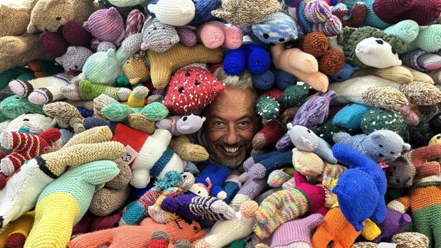 Mike King in a sea of donated knitted huggy bears. Photo / Supplied