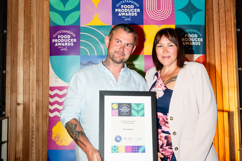 the kutai guy holding his award at the outstanding food producer awards