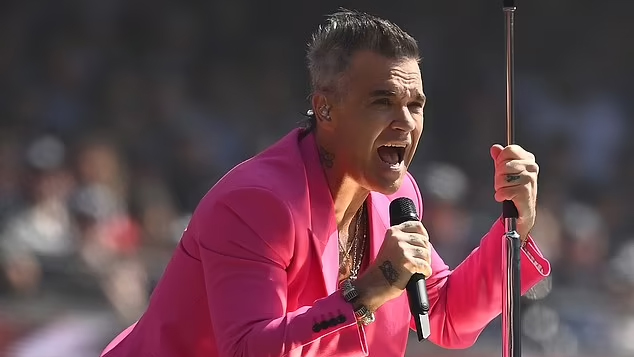 Robbie Williams pays touching tribute to John Farnham with electrifying cover of 'You’re the Voice' at AFL grand final