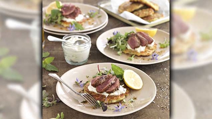 Lamb Medallions Served on Corn and Feta Fritters Topped with Fennel Tzatziki
