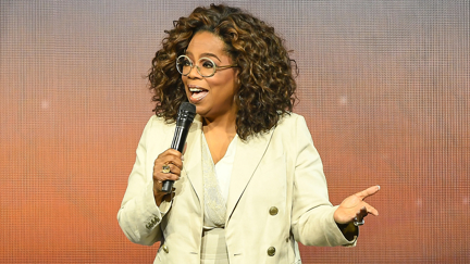 Oprah Winfrey dramatically faceplants on stage while ironically talking about balance