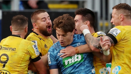 Beauden Barret gets dragged into Hurrican's try Celebration