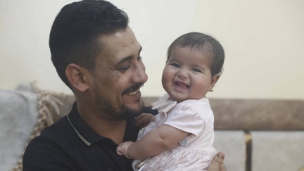 Syrian baby born under earthquake rubble turns six months, happily surrounded by her adopted family